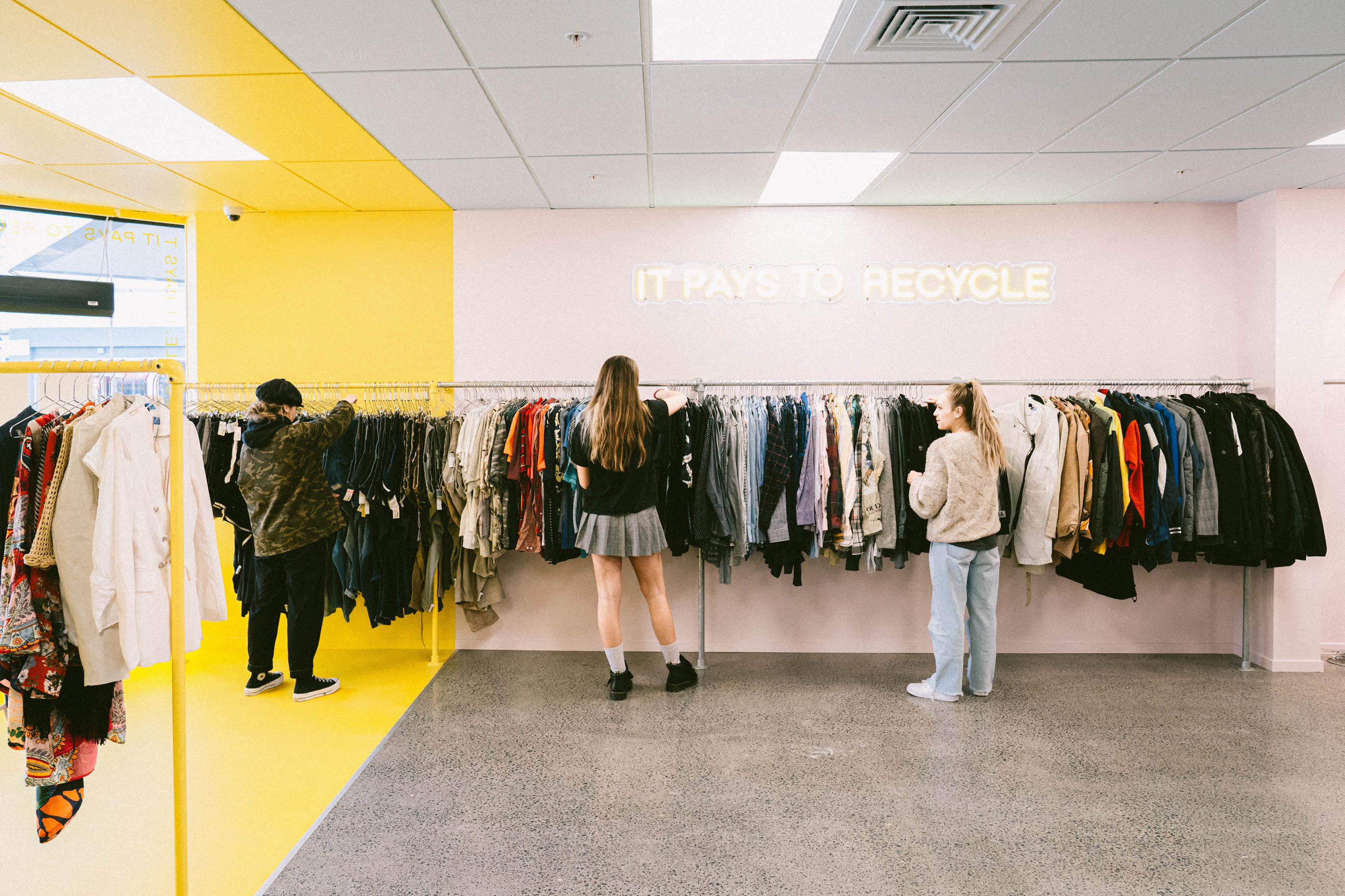 Highlighting design features in our Takapuna store - yellow feature wall and 'it pays to recycle' neon light.