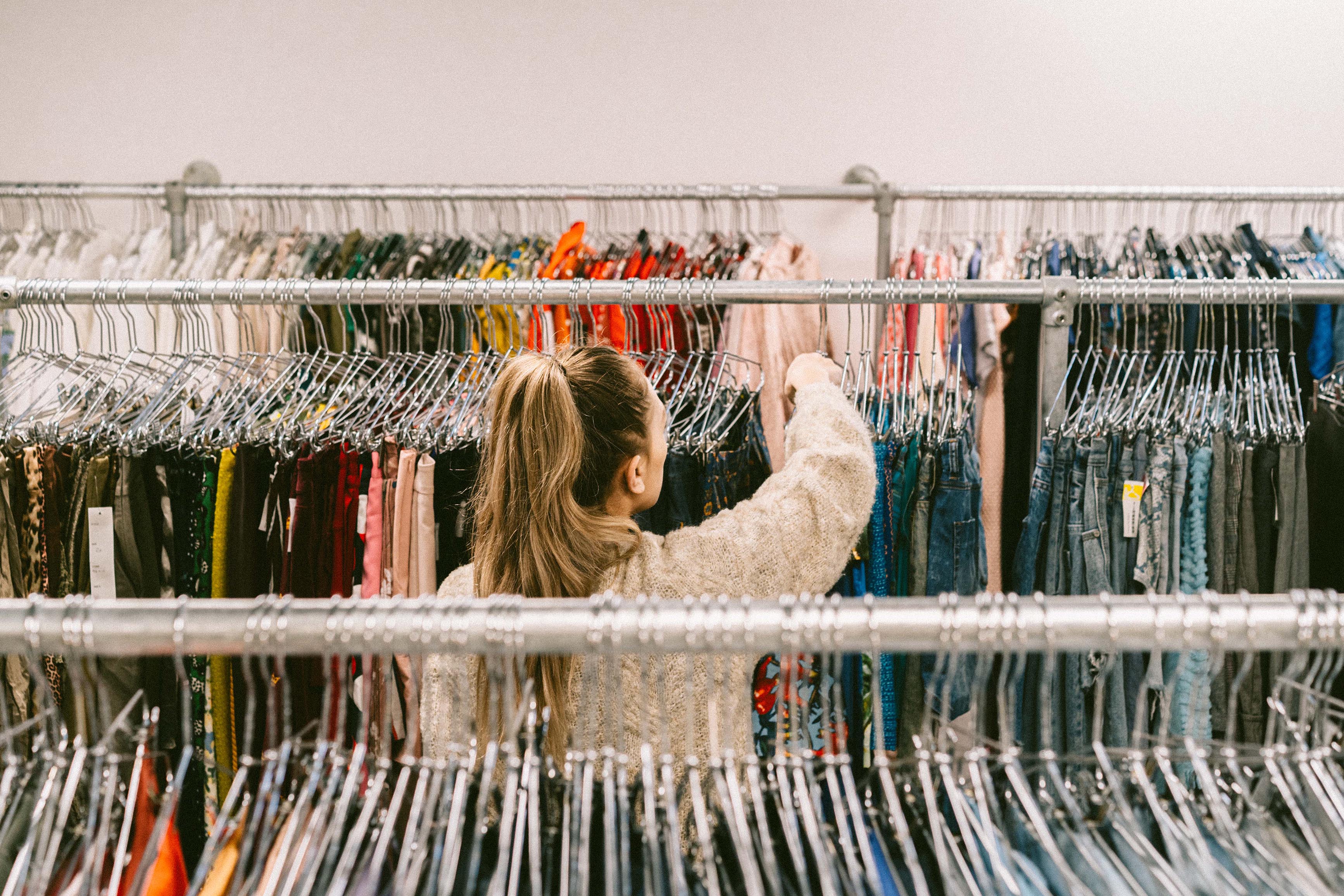 Person shops through our range of pre-owned clothing.