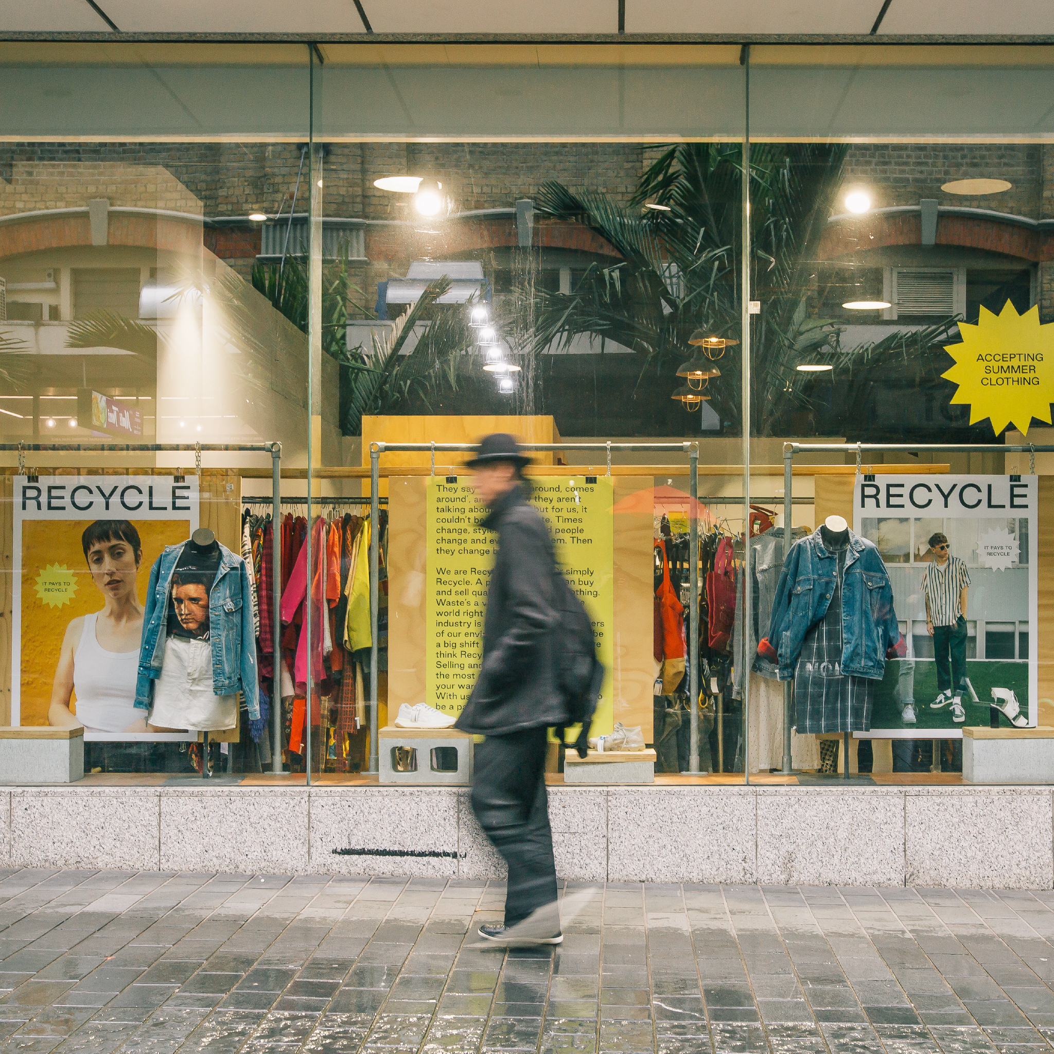 Person walks past our window display of designer and vintage pieces in Auckland.