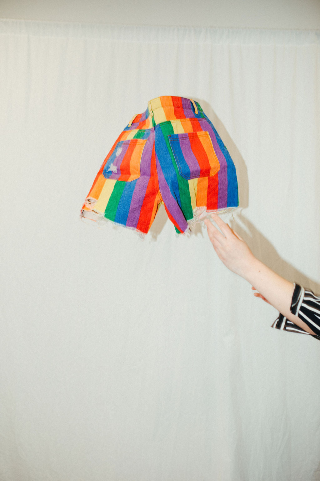 Pair of secondhand denim shorts thrown into the air