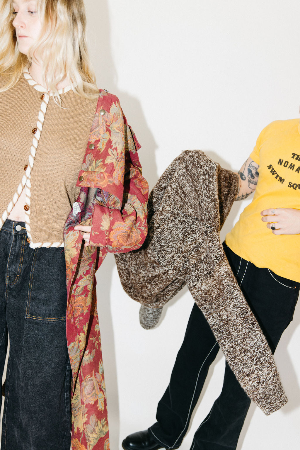 Two people trying on their sustainable purchases for size